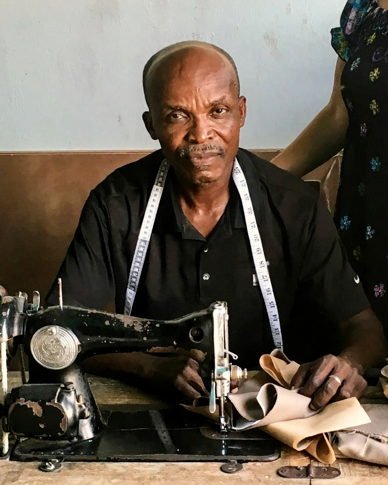 Tailor at his sewing machine in his workshop