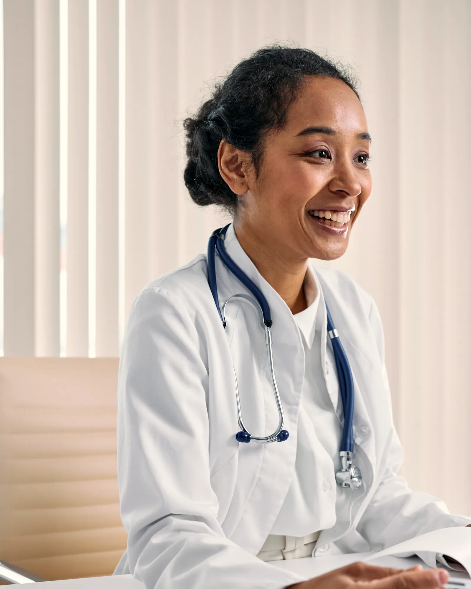 Smiling doctor at her desk in a modern practice