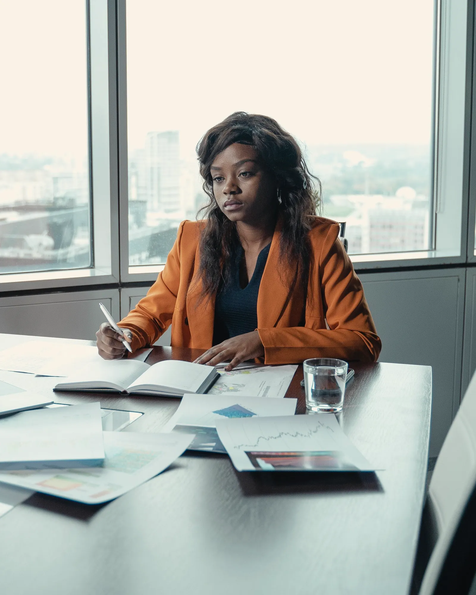 Executive reviewing reports in a high-rise boardroom